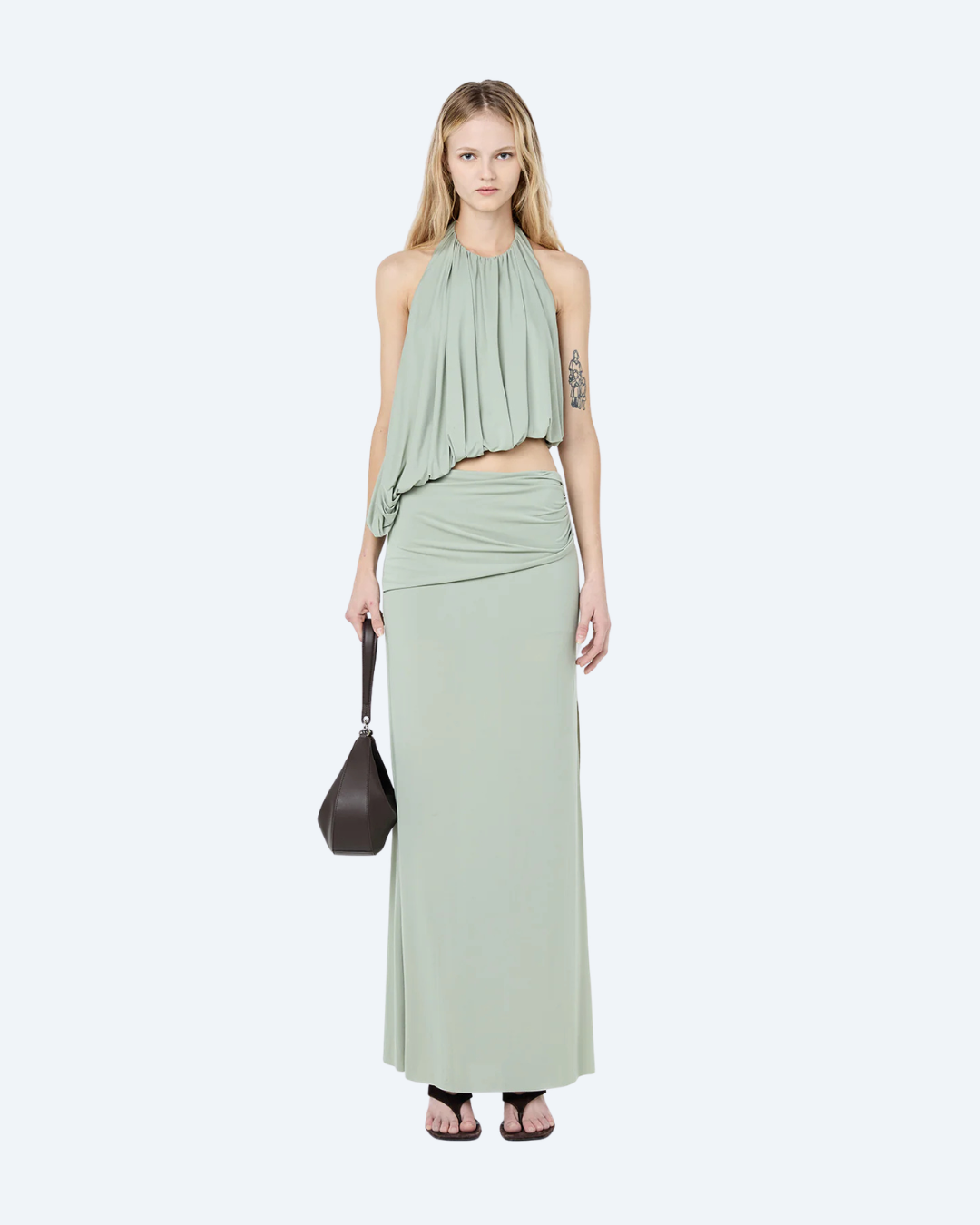 Woman wearing a pistachio Bec & Bridge Cadence Racer backless, maxi dress, front view, on a white background