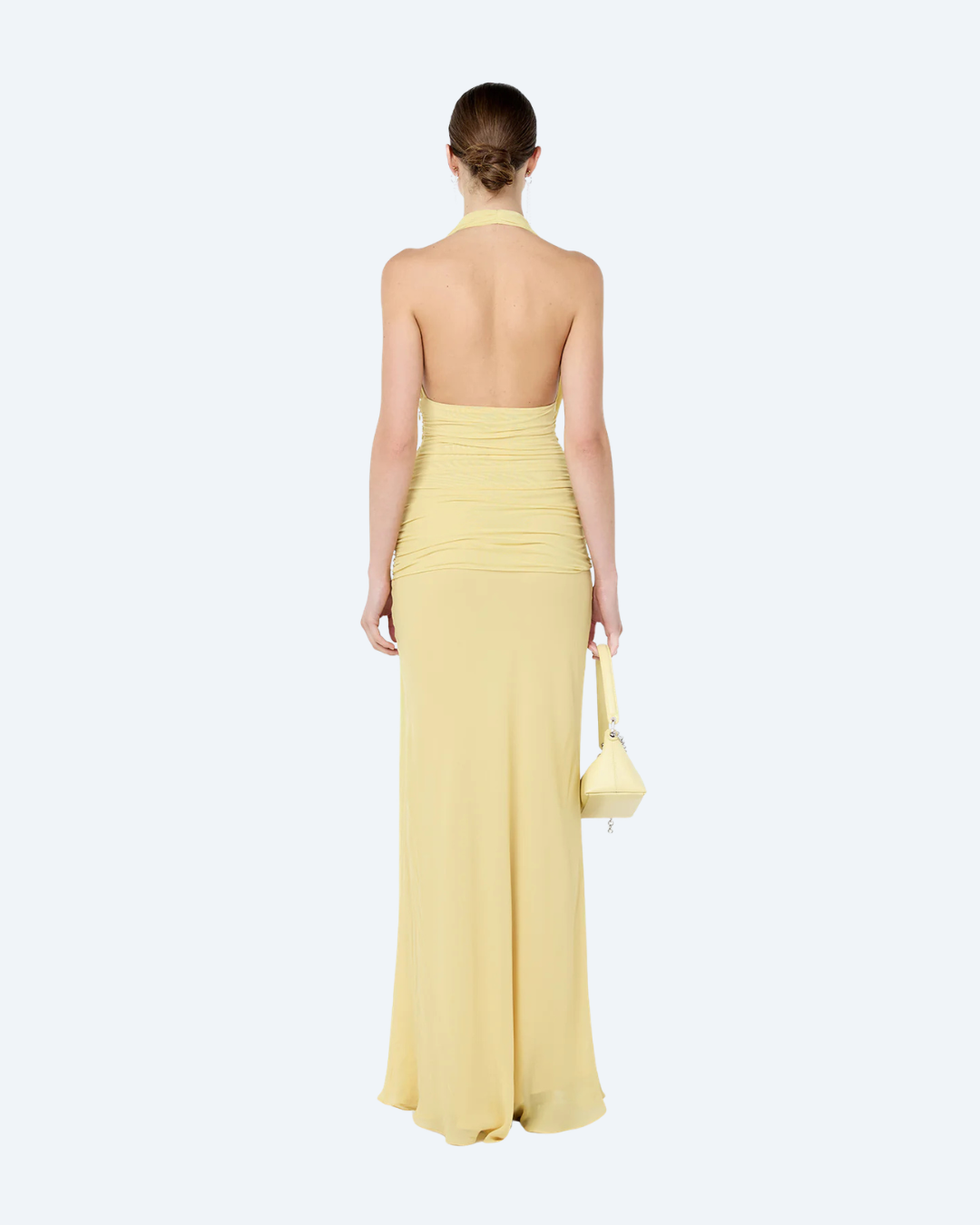 Woman wearing a yellow Bec & Bridge Cassis Drape backless, maxi dress, back view, on a white background