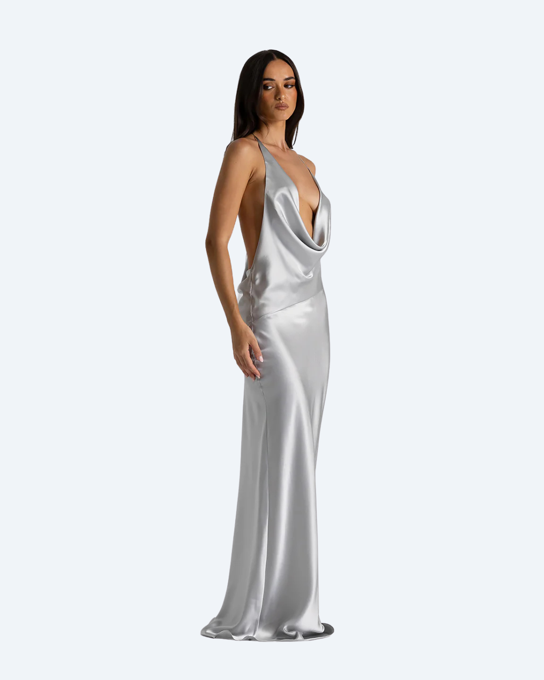 Woman wearing the Gabi Gown by Natalie Rolt, a silver satin side view dress on a white background