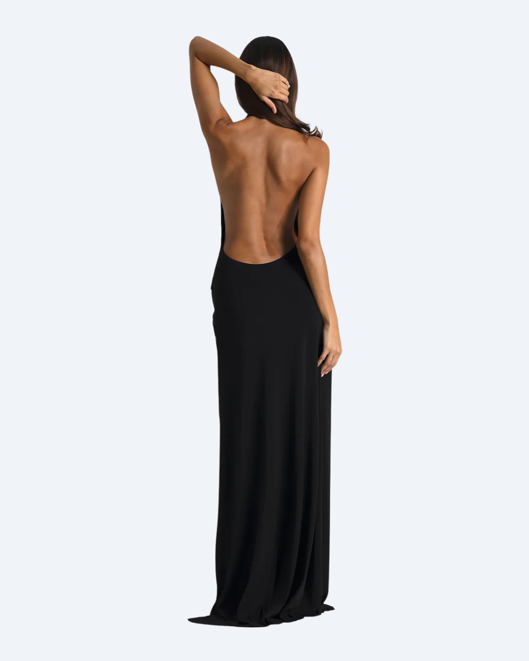 Woman wearing the Winona Gown by Natalie Rolt, a black evening gown with sheer panels back-view dress for hire by Dresscode on a white background