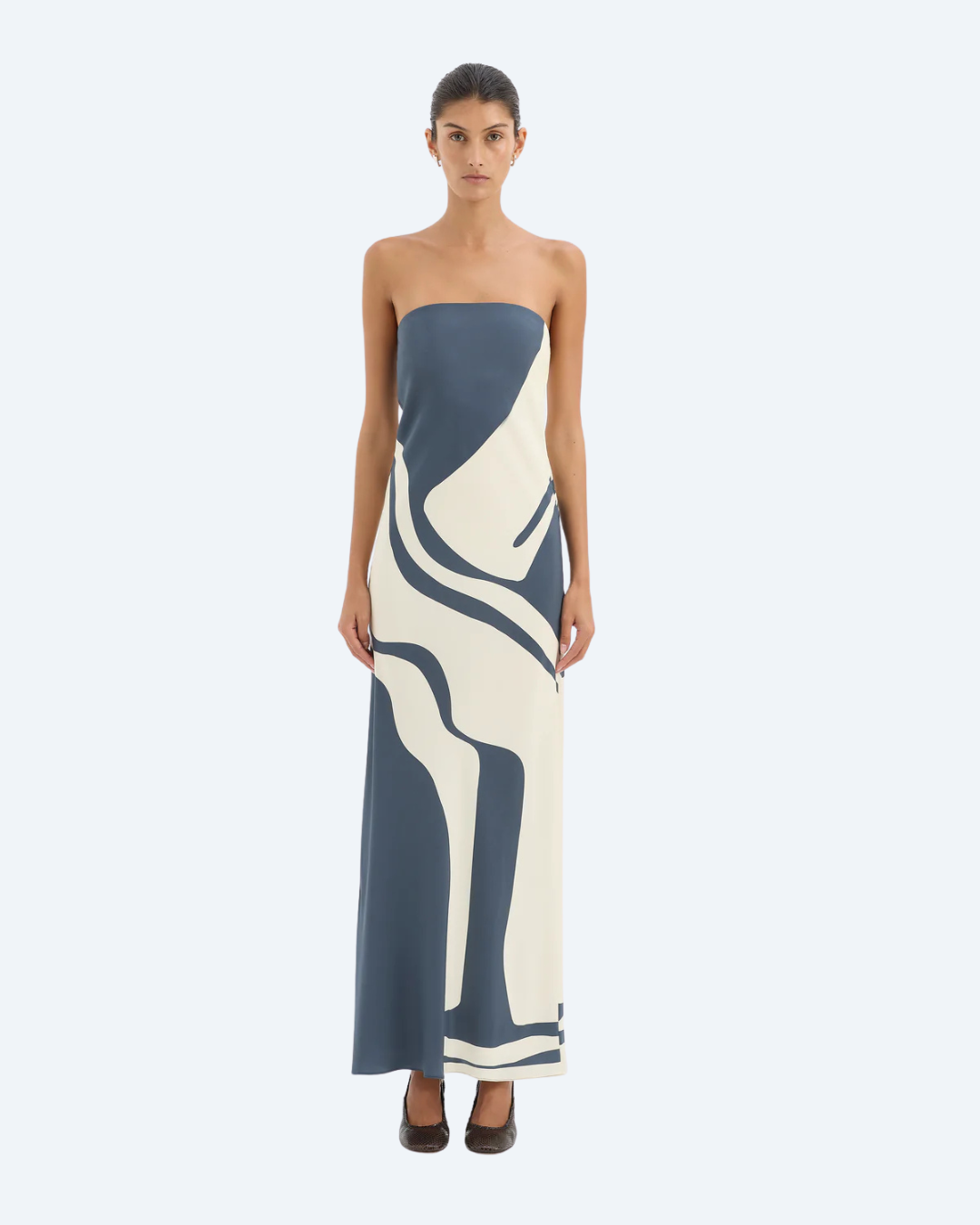 Woman wearing Sir the Label Lilou strapless dress with abstract pattern, front view, on a white background