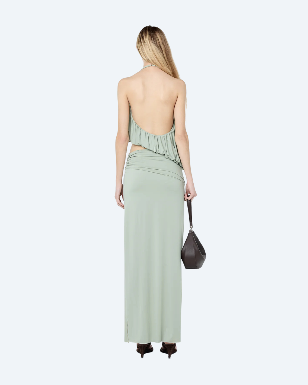 Woman wearing a pistachio Bec & Bridge Cadence Racer backless, maxi dress, back view, on a white background