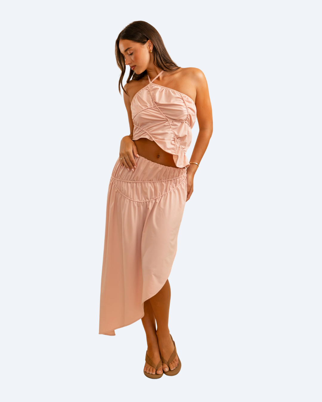 Woman wearing Koster Kulture pink fleur top and skirt set on light gray background, stylish two-piece outfit. front view 2